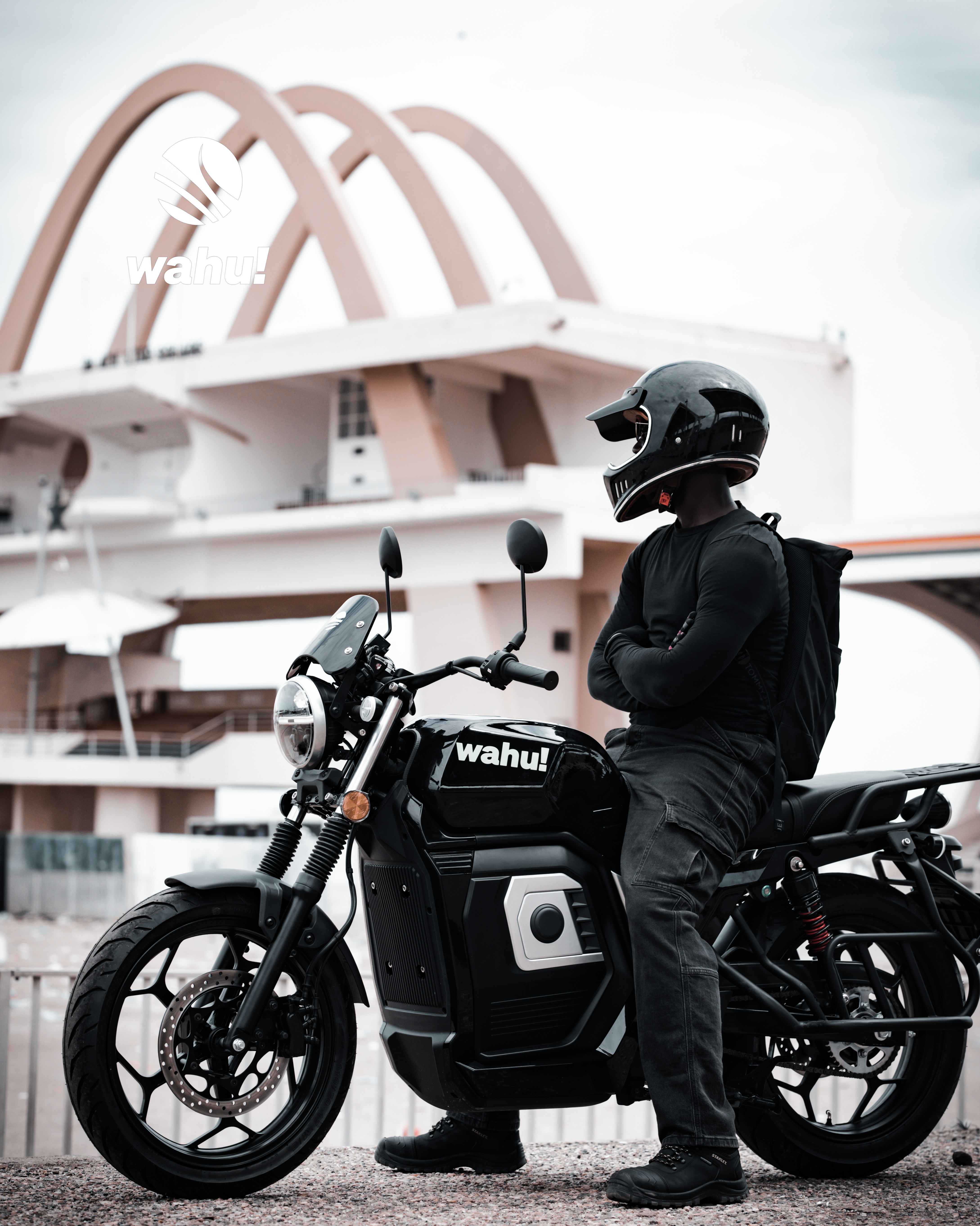 Wahu eMoto rider in front of Independence Arch, Accra