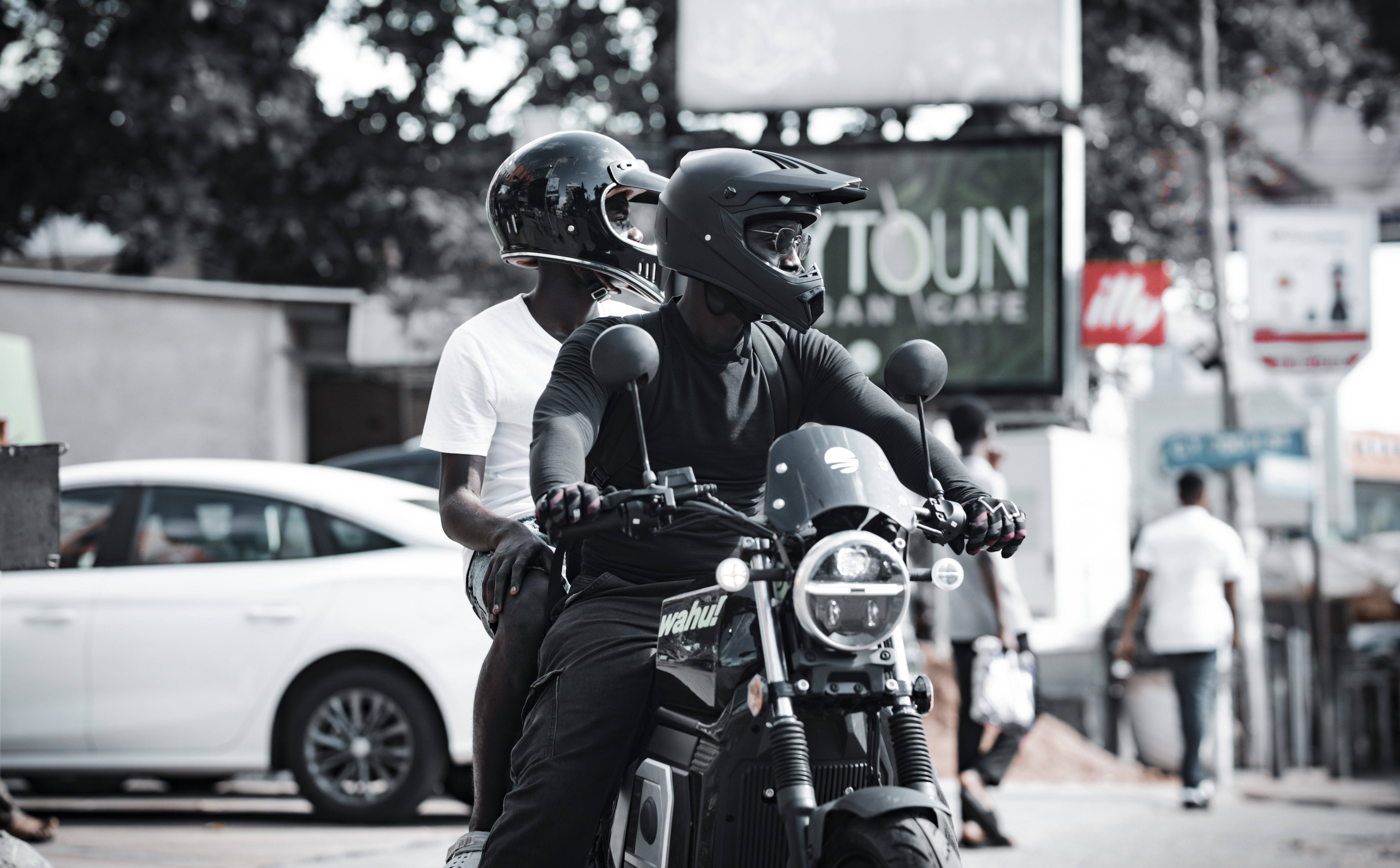 Two Wahu eMoto riders on a city street