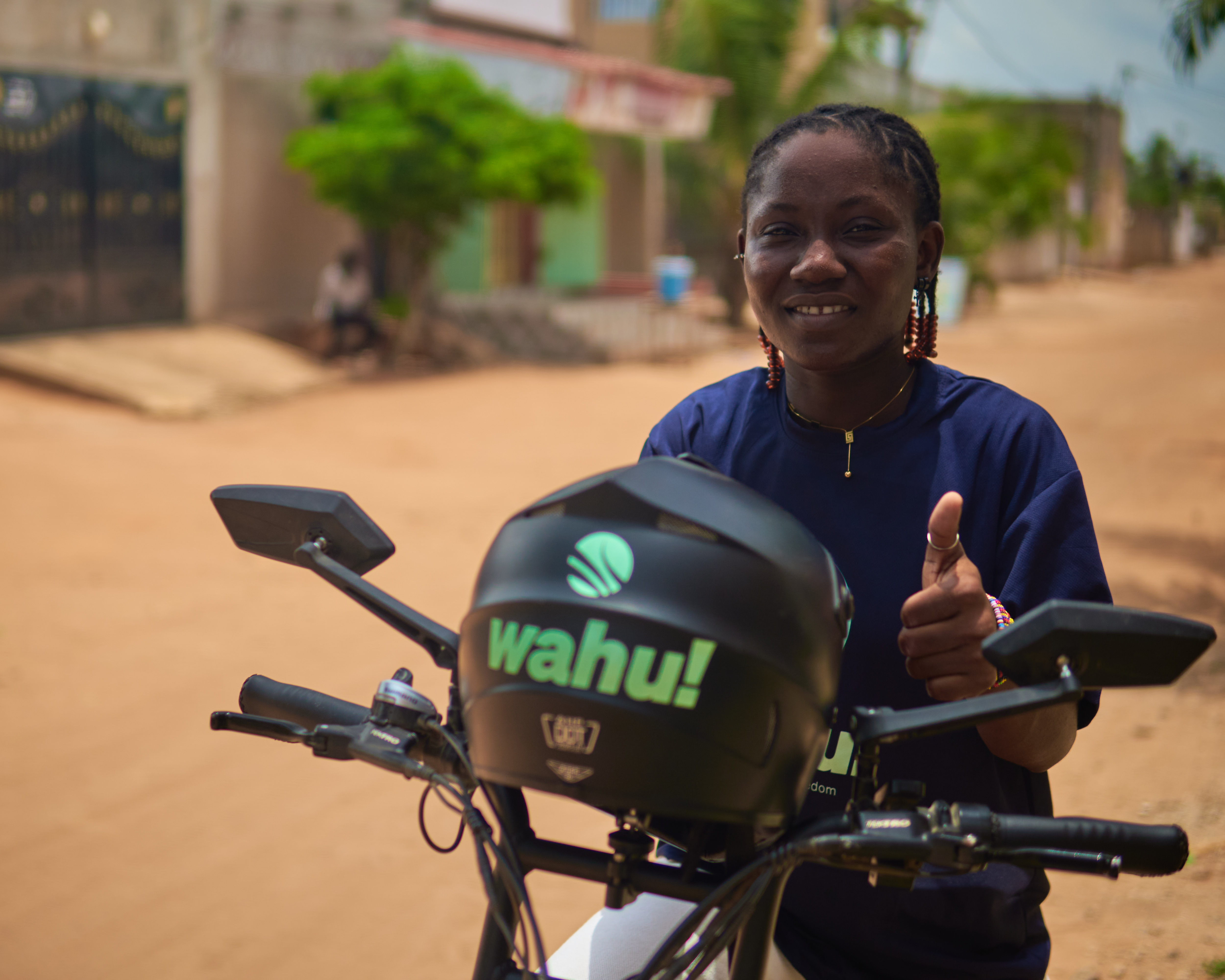 A Wahu rider with her eMoto, thumbs up