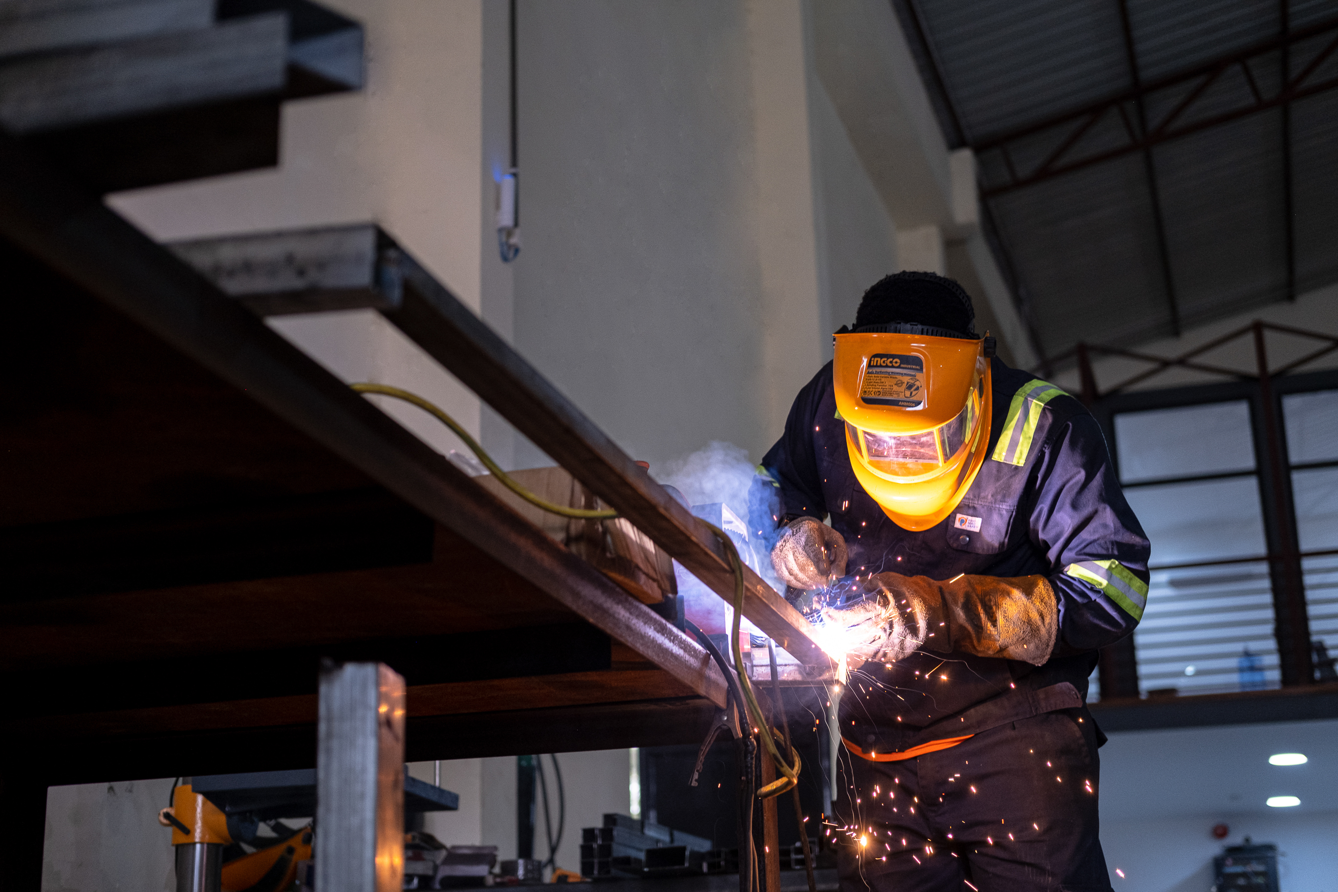 A Wahu technician welding a chassis frame in the Accra workshop