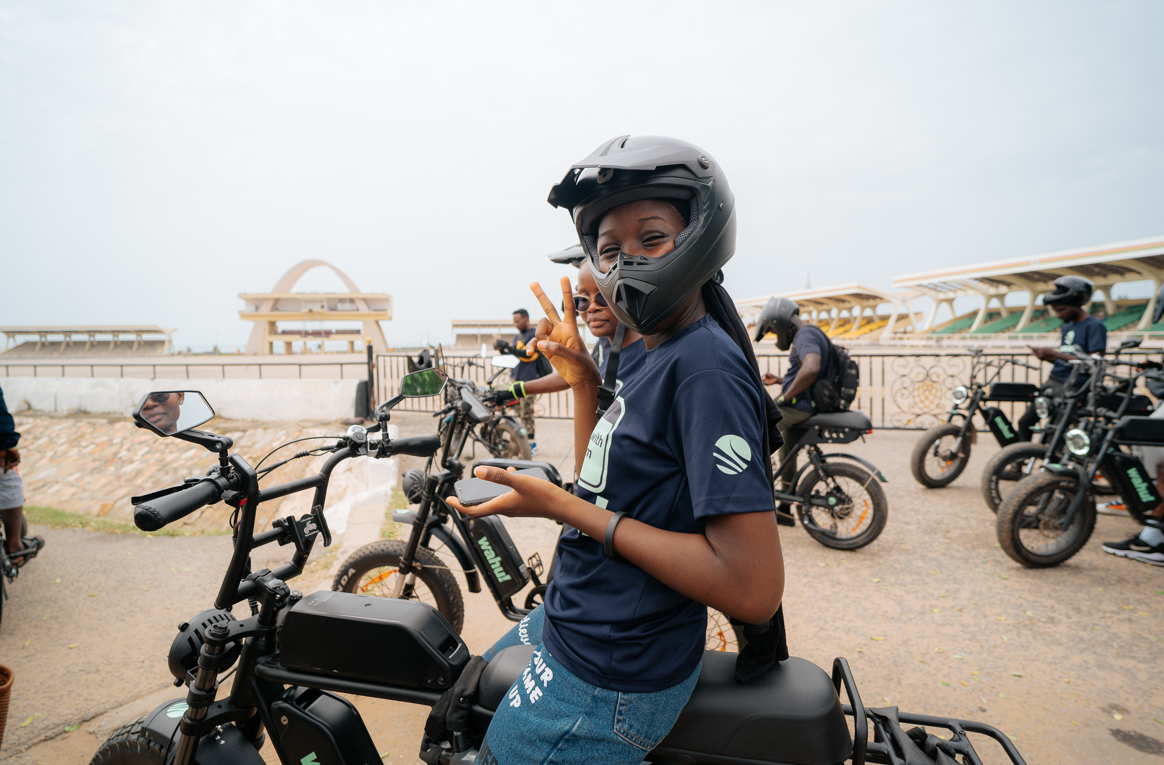 A Wahu rider in helmet flashing a peace sign at Independence Square